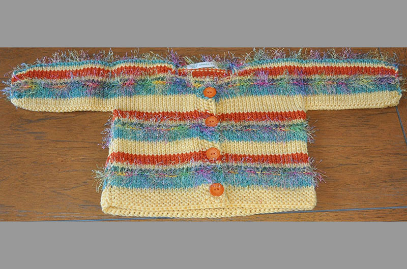 Cream with reddish orange and blue stripes